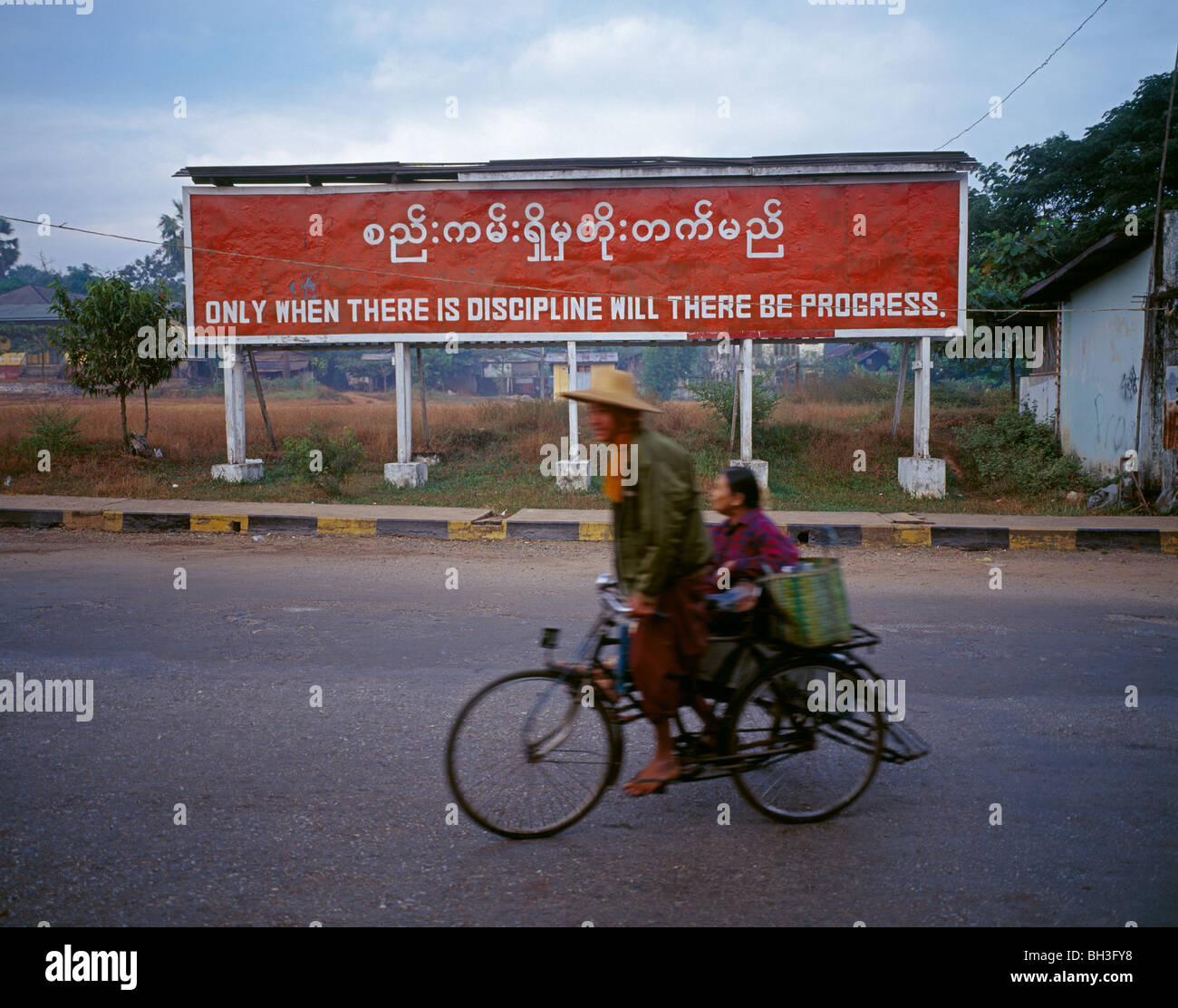 Slogan of the government in a street demanding more discipline for achieving more progress Parole der Regierung Myanmar Burma Stock Photo