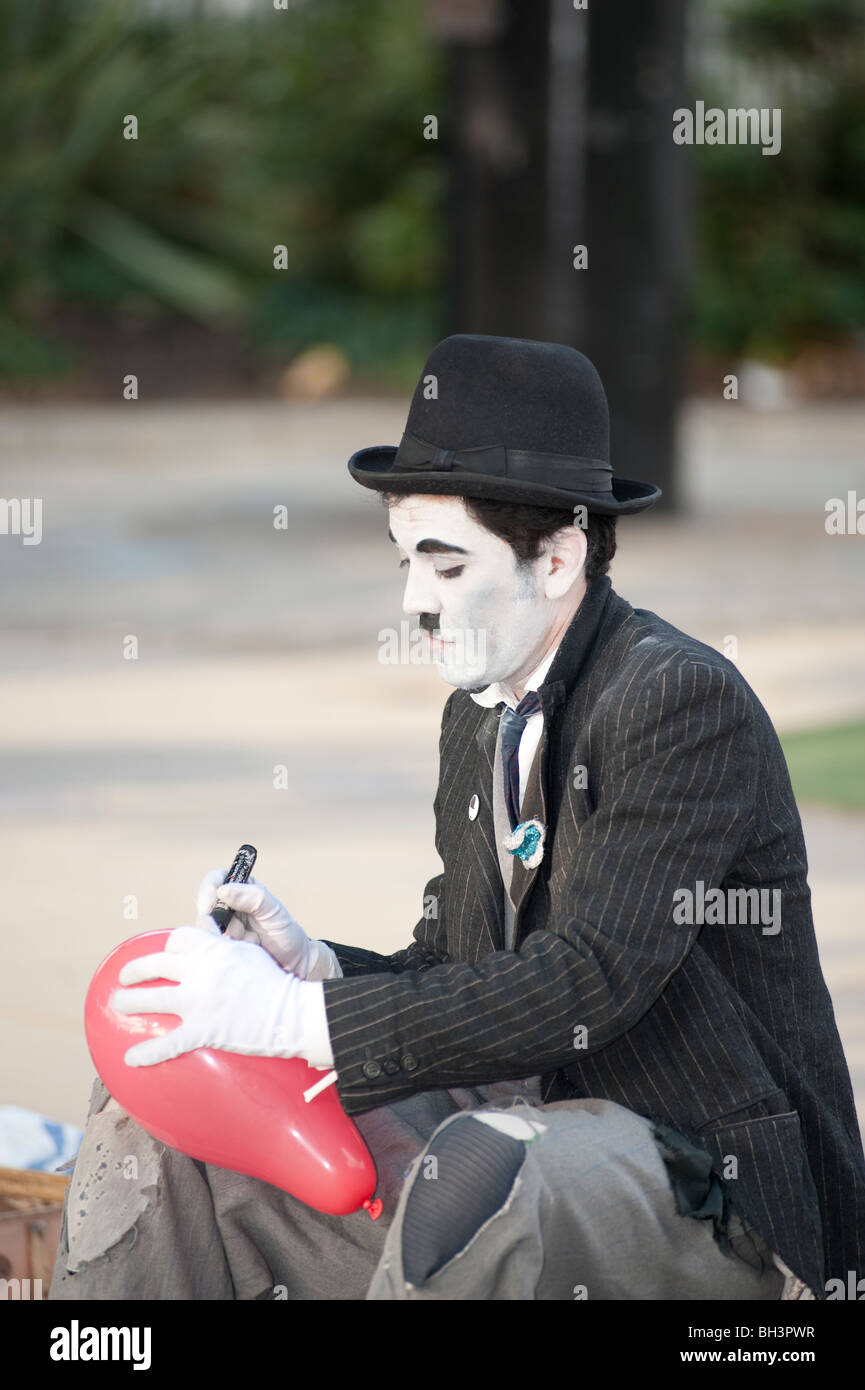 Street performer dressed as Charlie Chaplin on London's South Bank. This area is famous for performers from around the world. Stock Photo