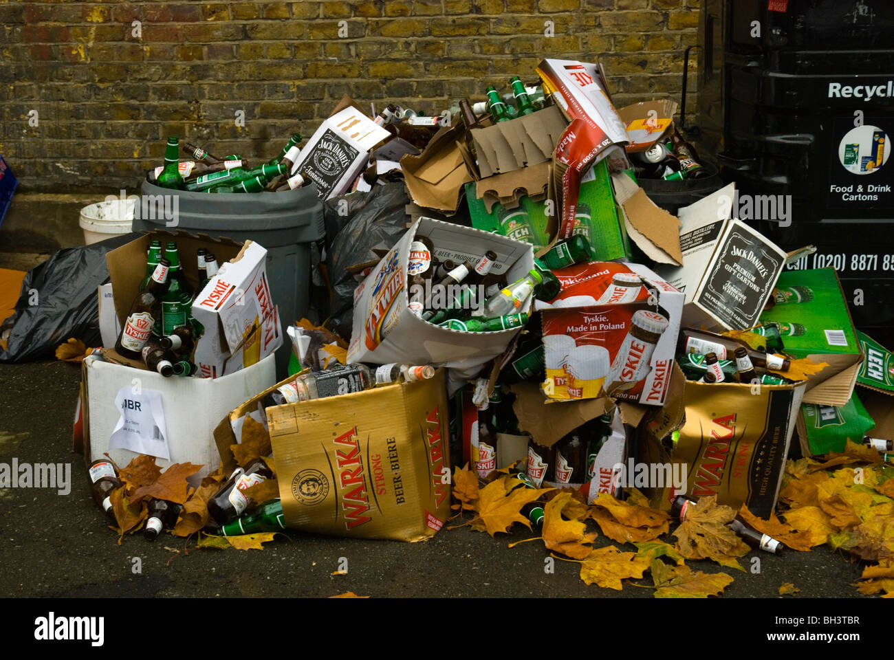 Empty Polish beer bottles and cardboard boxes in front of recycling bins Tooting London England UK Europe Stock Photo