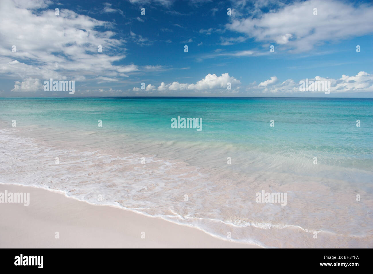 A deserted tropical beach and calm sea Stock Photo