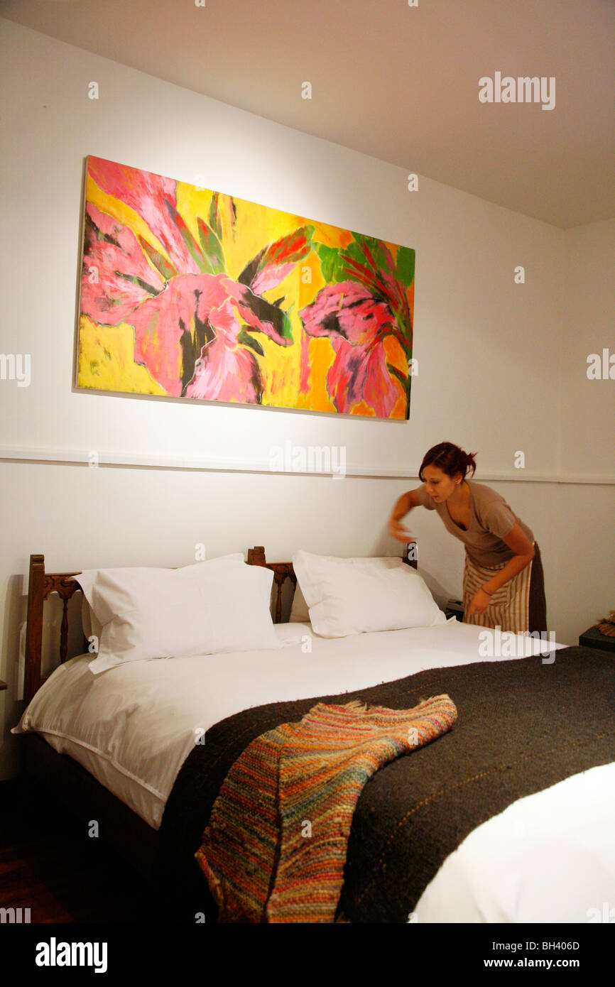 Maid making a room at Finca Adalgisa hotel, Mendoza, Argentina. Stock Photo
