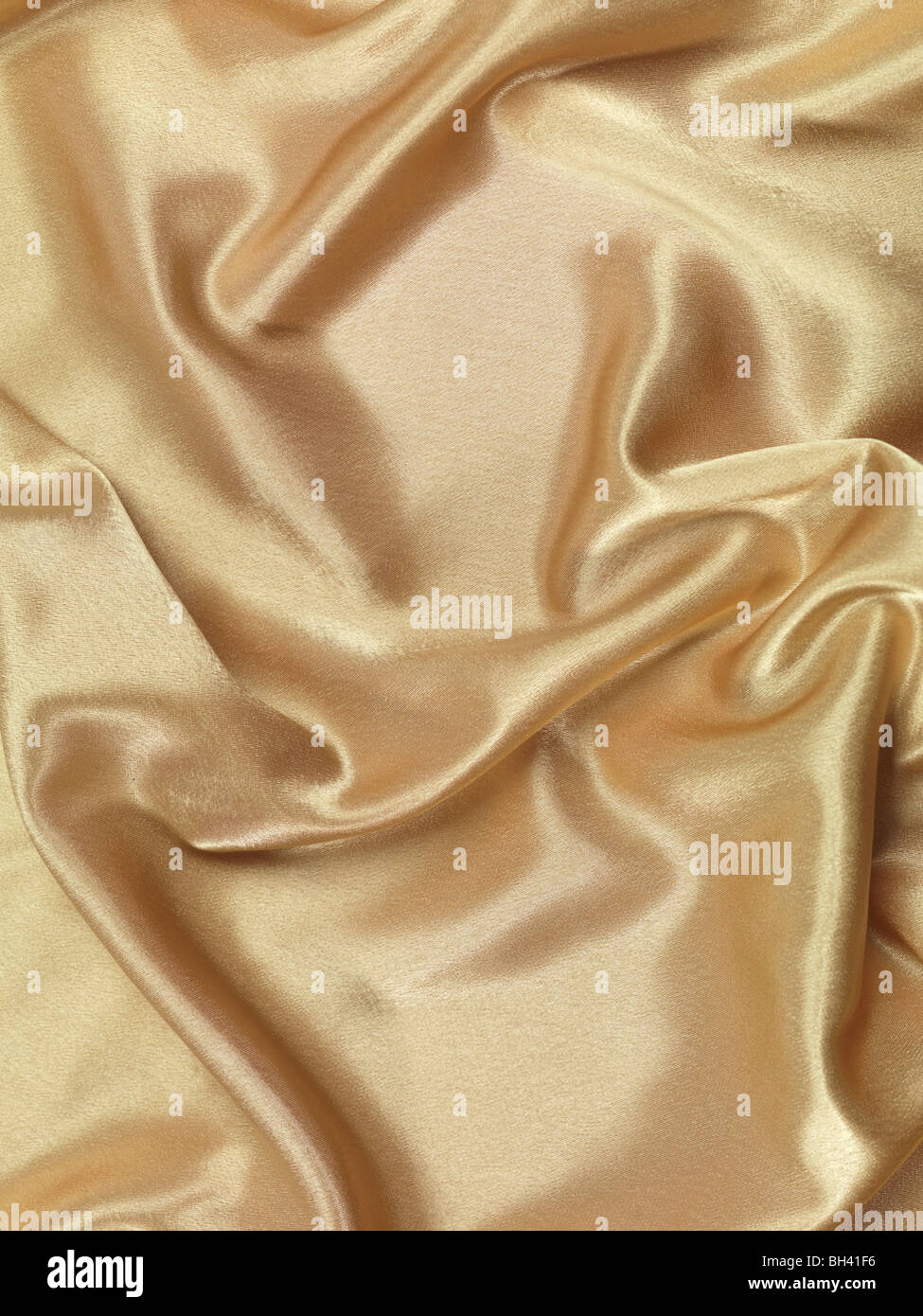 Golden shiny silky fabric background Stock Photo