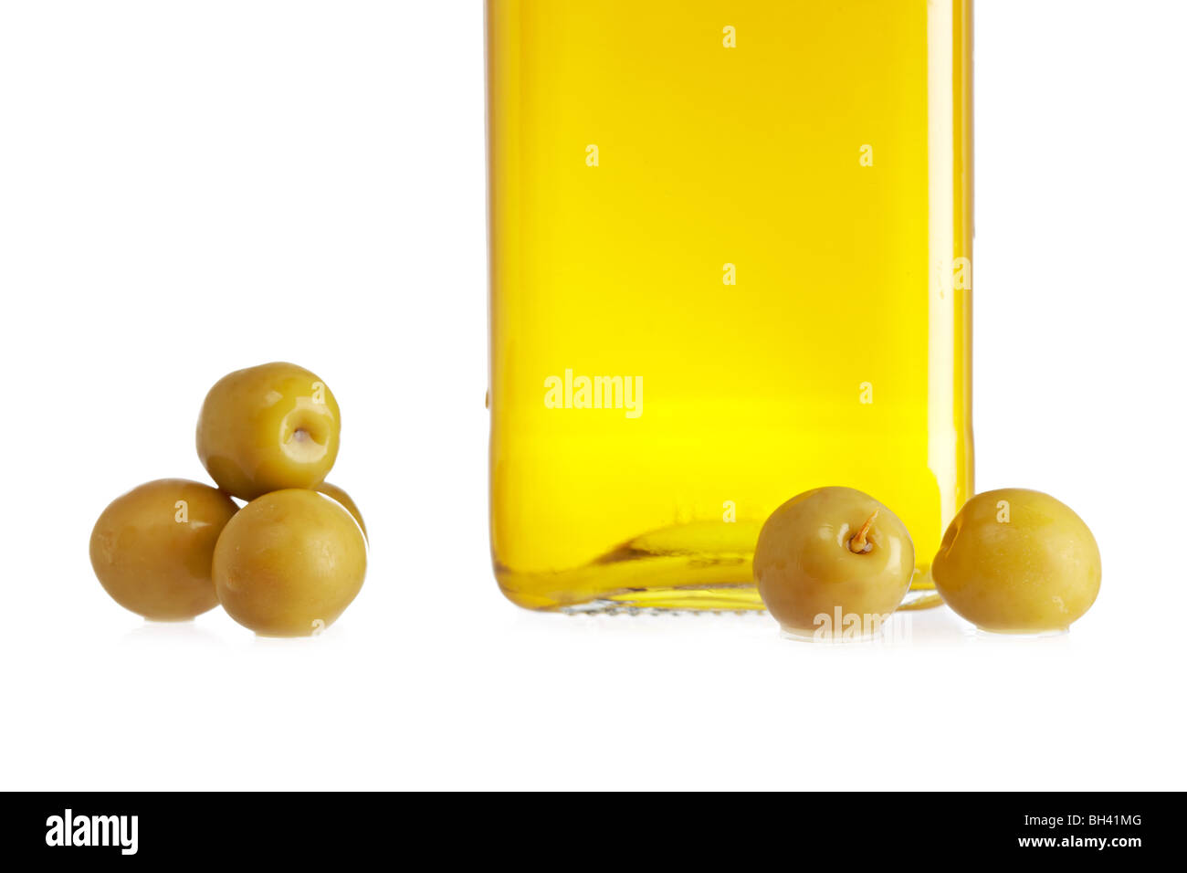 Olive oil bottle and some olives isolated on white background Stock ...