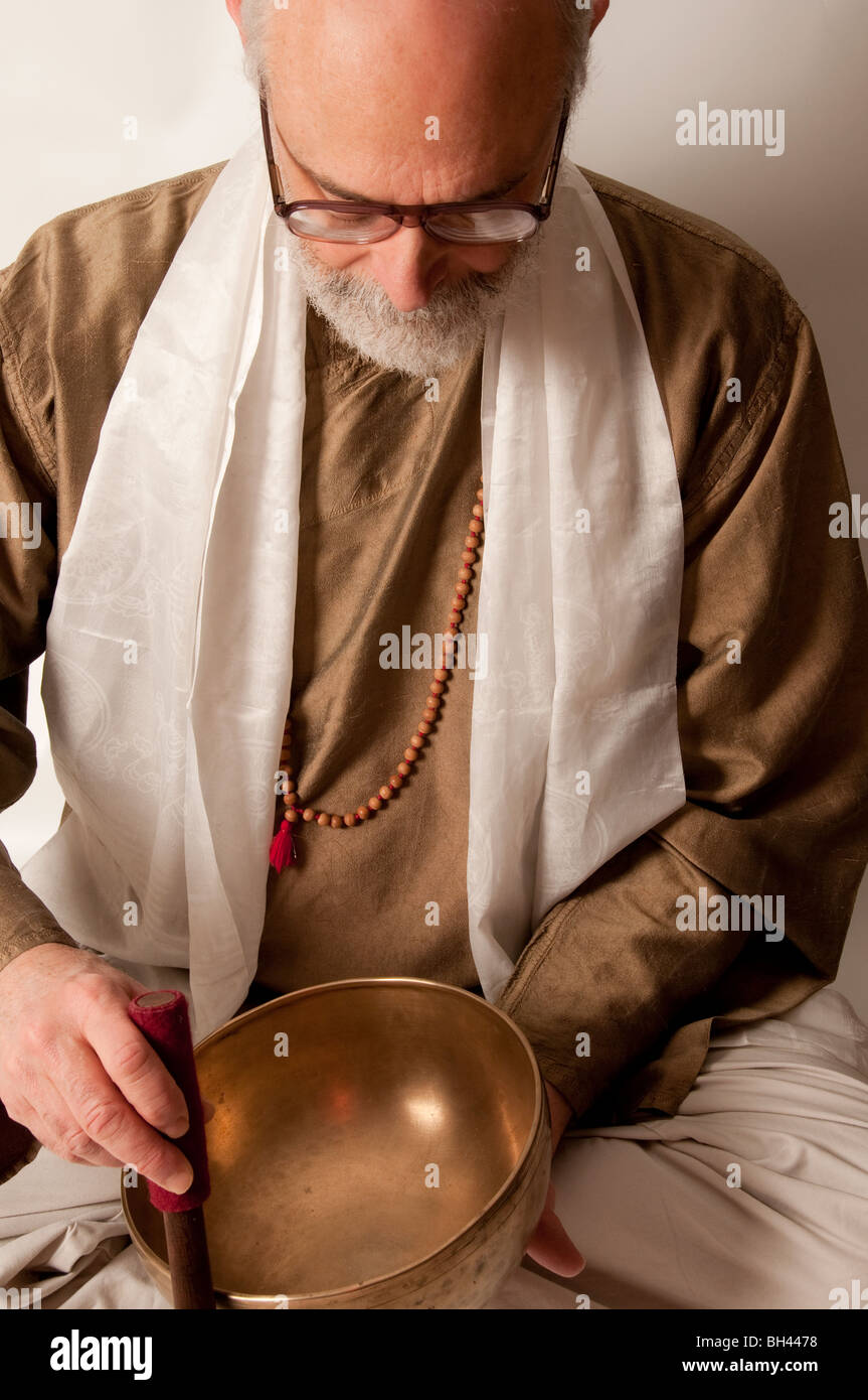 Tibetan bowl practitioner using sacred sound as healing therapy chakra