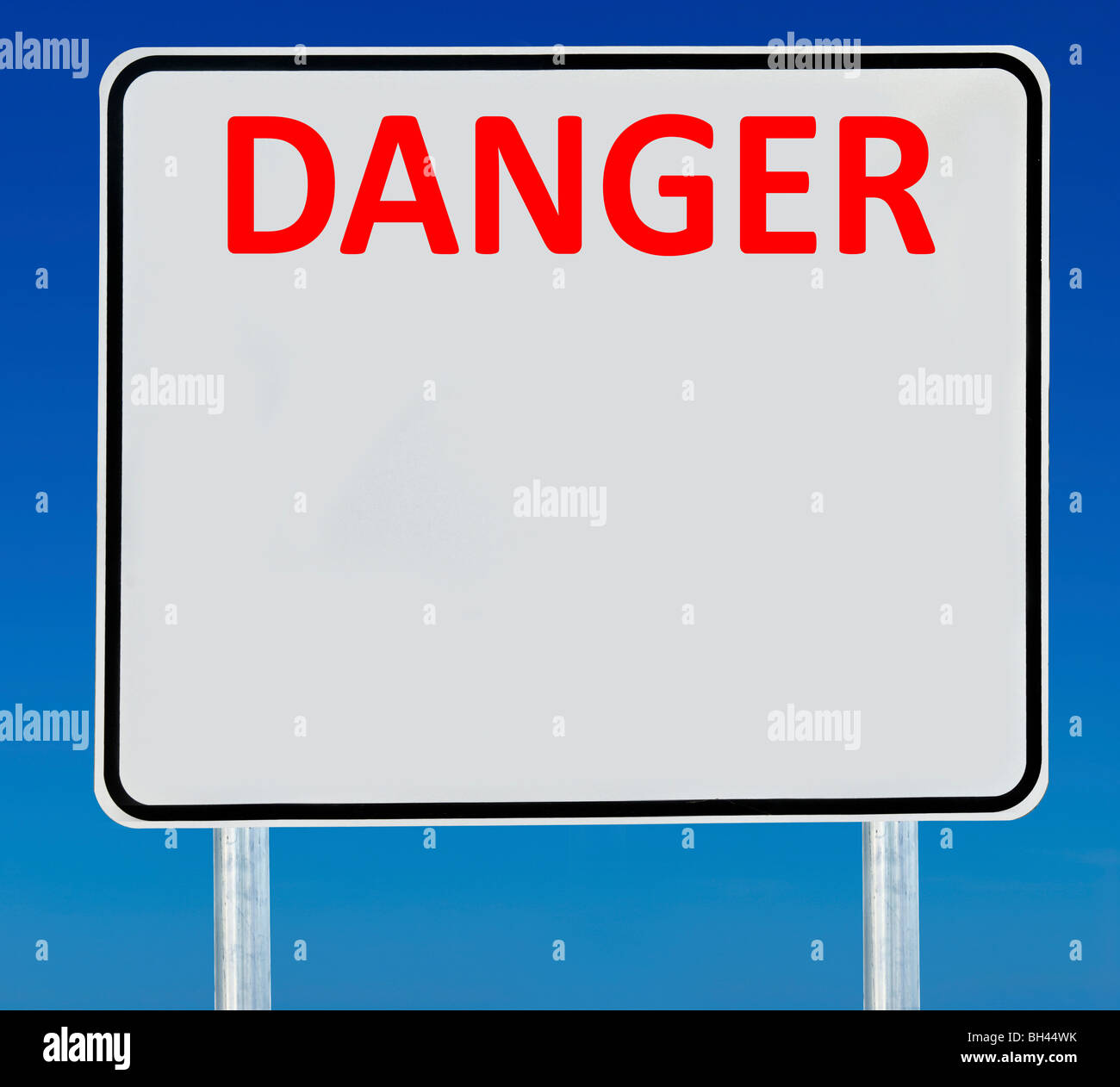 A 'Danger' road sign isolated on a blue graduated sky. Stock Photo