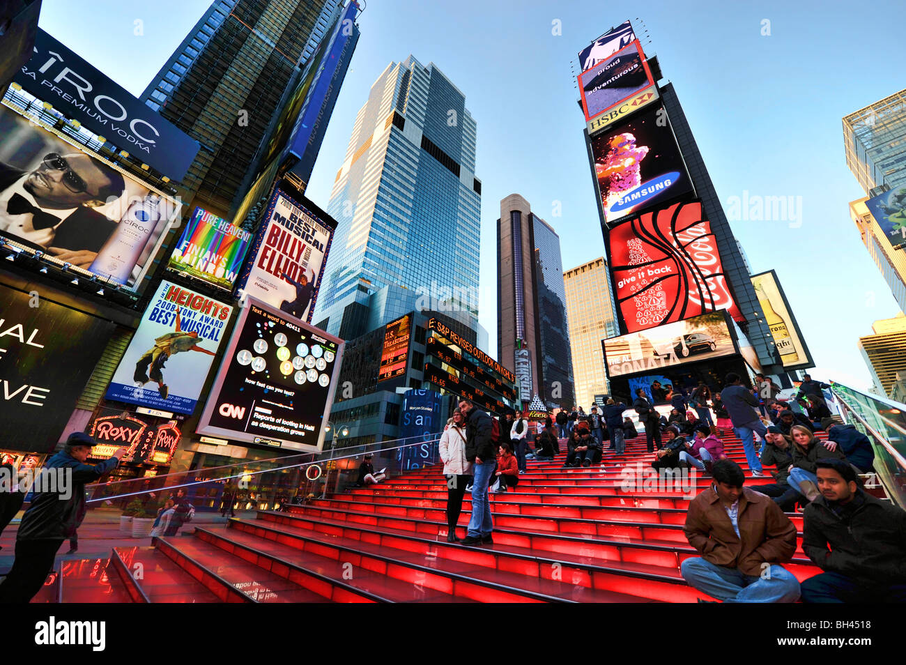Tourists on the Illuminated Stairway of the Duffy Square TDF TKTS Booth, Times Square, Broadway