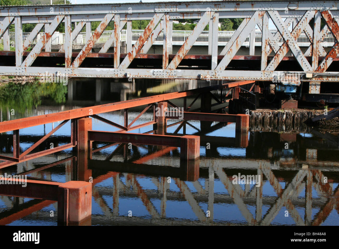 Iron bridge construction over and reflected in the Caledonian Canal. Stock Photo