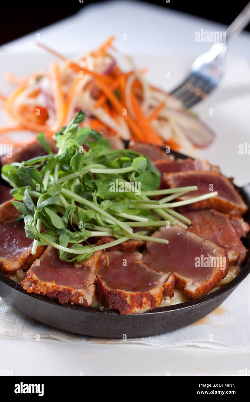 Sliced Tuna Seared Rare with a julienned Vegetable Salad Stock Photo