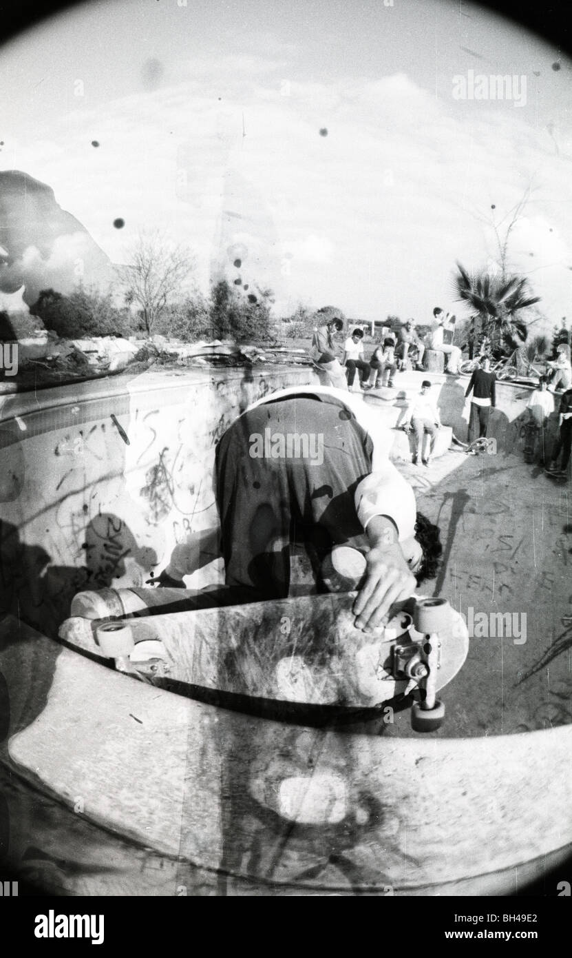 Karma Tsocheff does a backside grind in an empty swimming pool. 1988