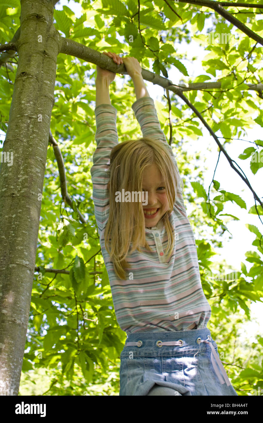 Girl in Tree in woodland Stock Photo - Alamy