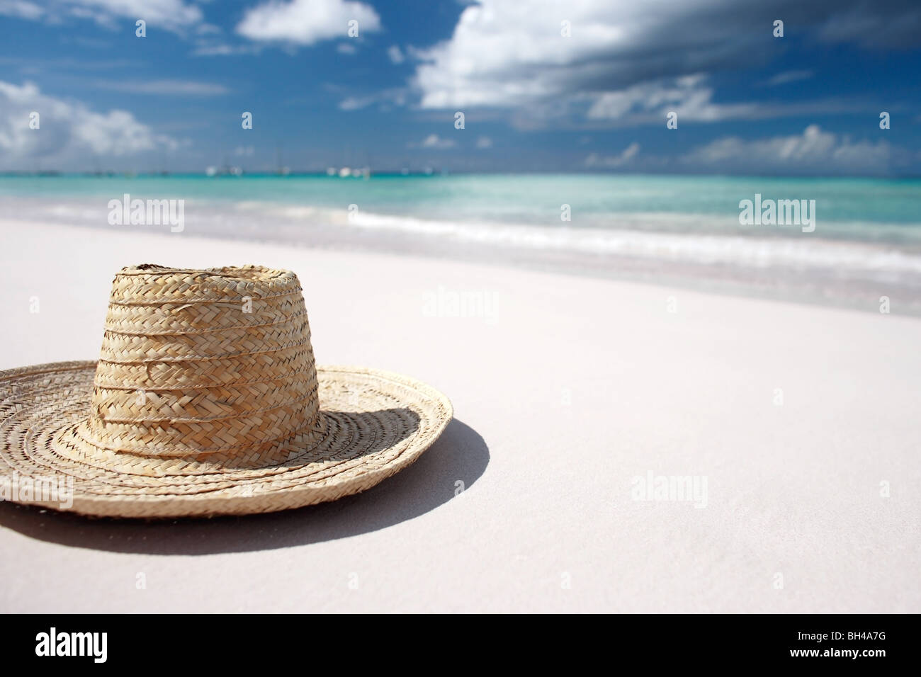 A straw sun hat lying on a white sandy tropical deserted beach Stock ...