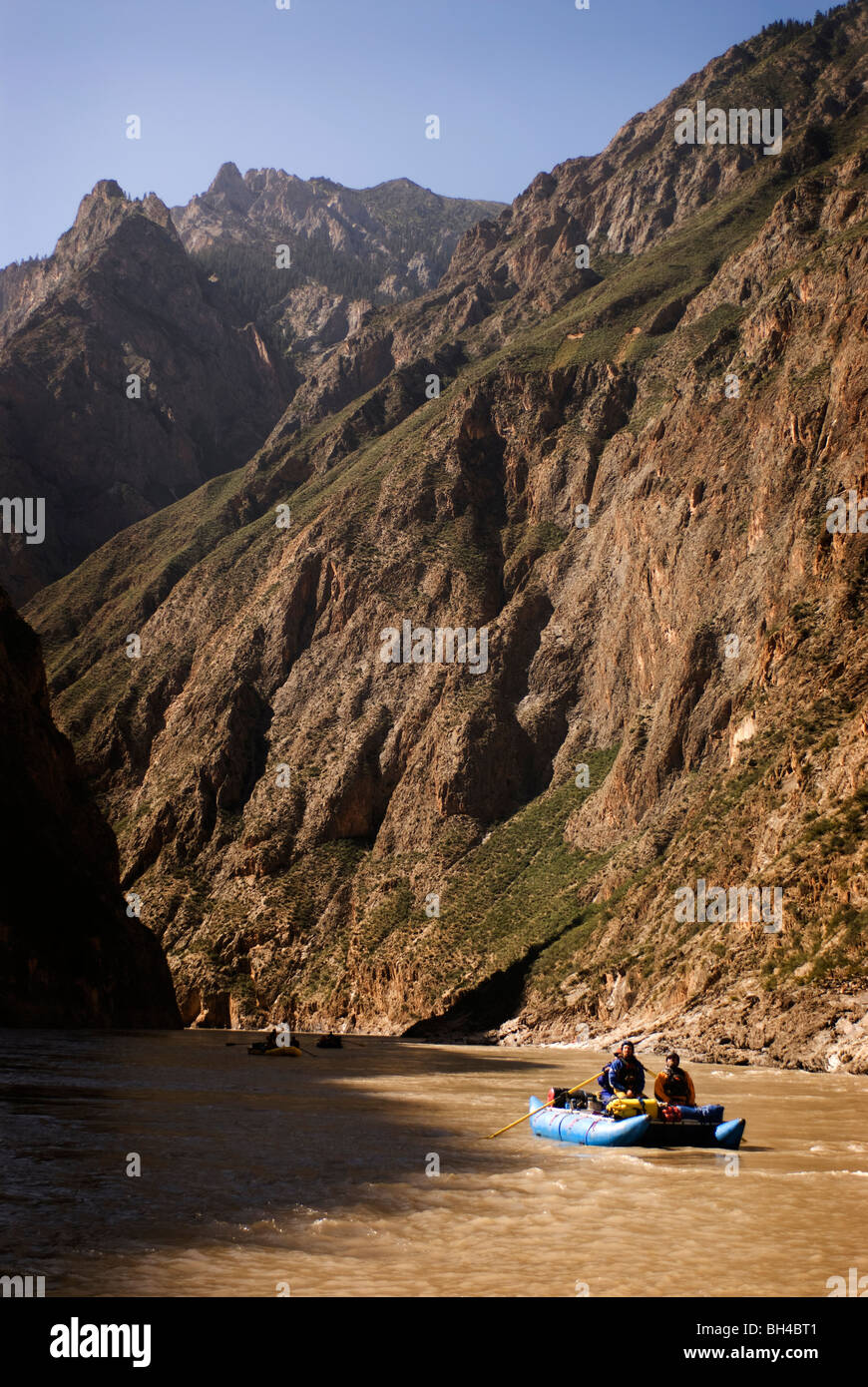 Rubber rafts row downstream during a whitewater rafting trip in Western ...