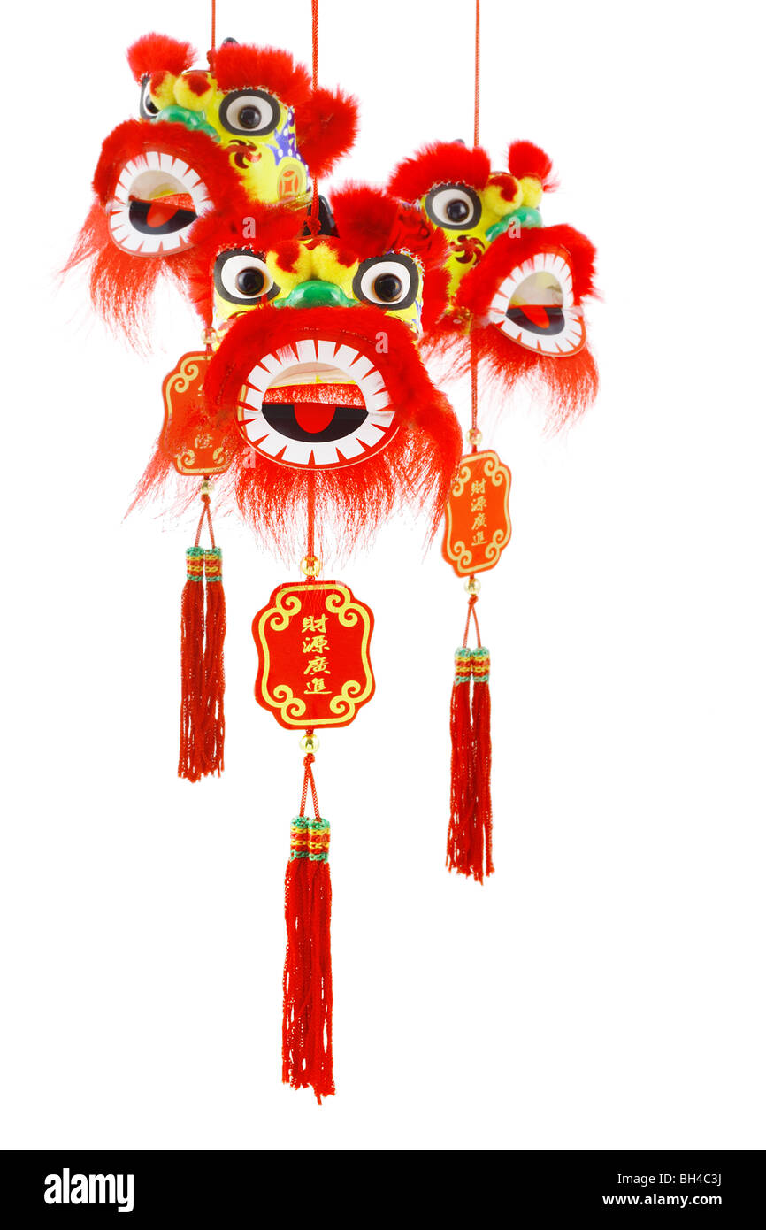 Three hanging Chinese new year lion head ornaments on white background Stock Photo