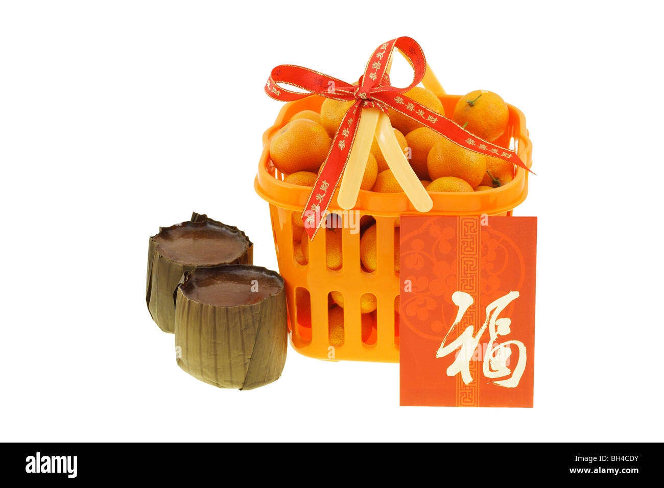 Gift basket of mandarin oranges and Chinese new year rice cakes on white background Stock Photo