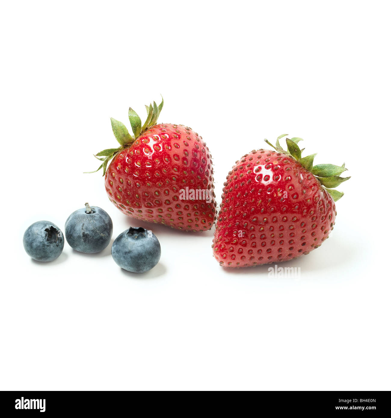 Blueberries and a strawberry on a white background Stock Photo