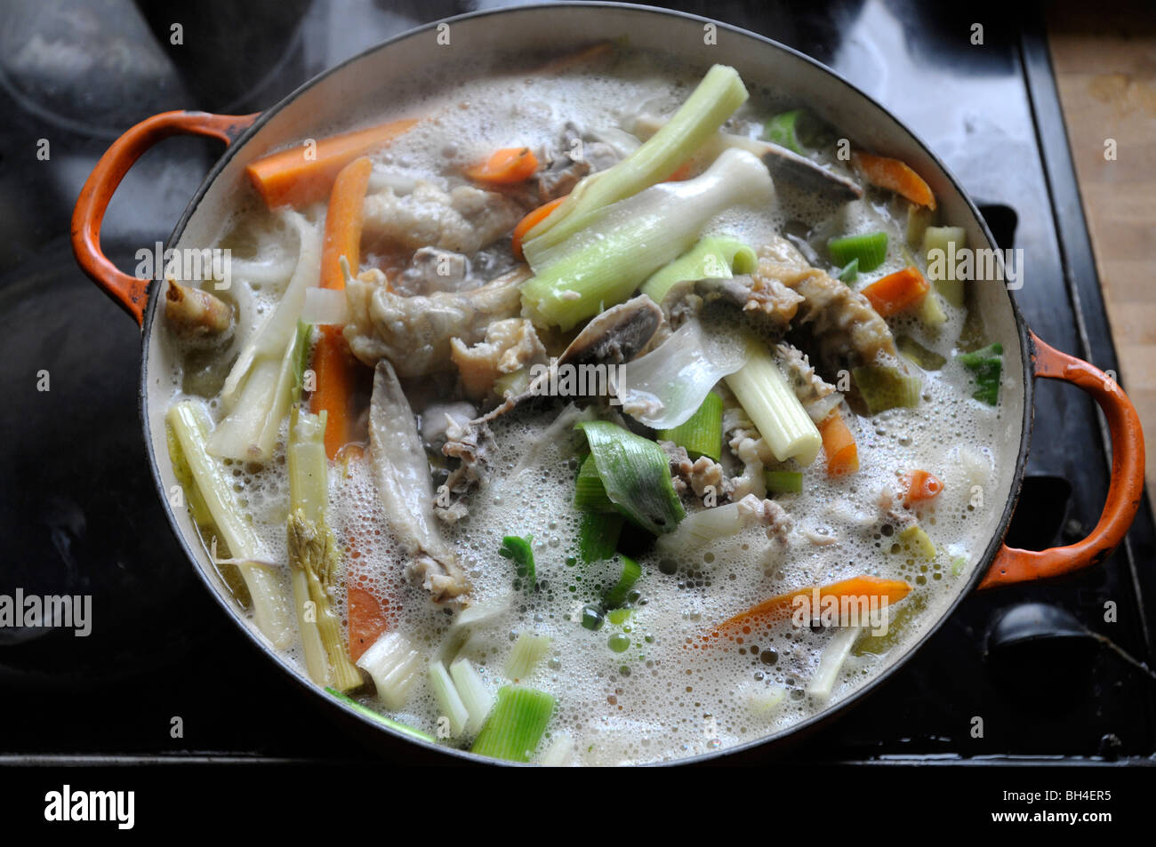 A pot of Chicken stock coming to the boil Stock Photo - Alamy