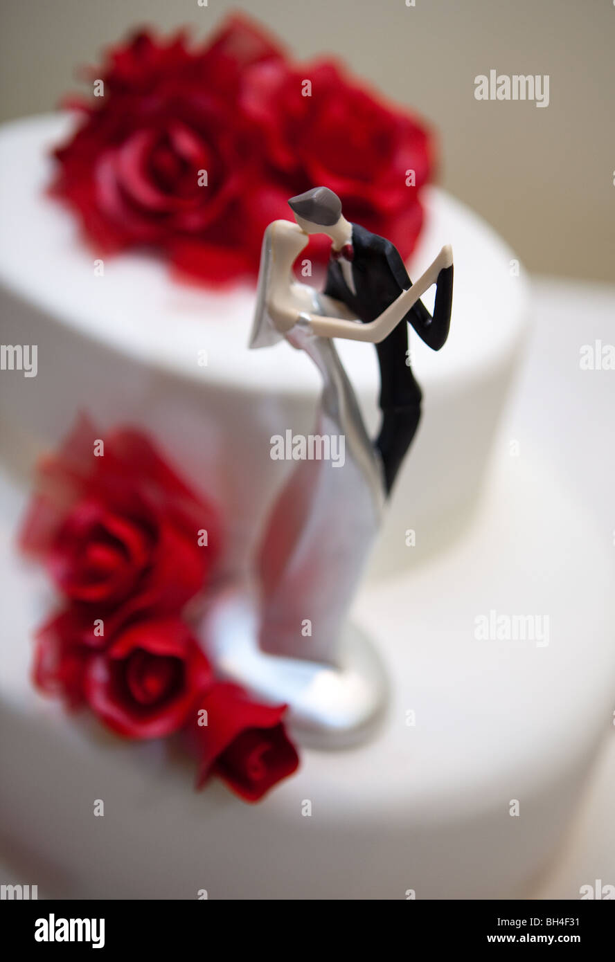 Wedding cake with bride and groom on top Stock Photo