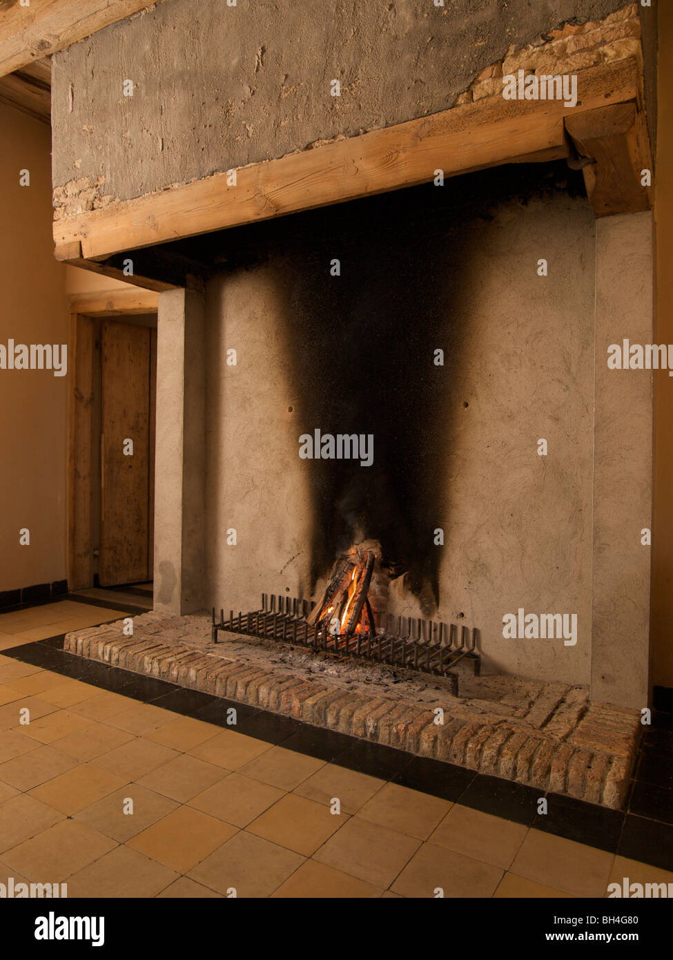 Wood fire burning in 17th century fireplace. Ulvenhout, Noord Brabant, the Netherlands Stock Photo