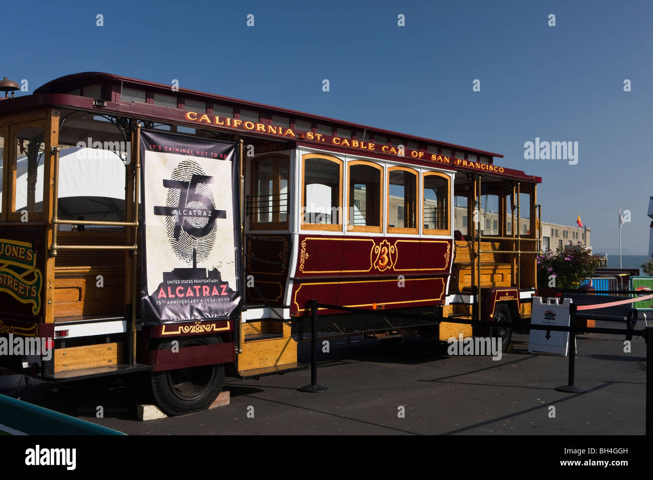 A California Street Cable Car of San Francisco is parked at Pier 33 where tourists board ferries to Alcatraz Island San Franciso Stock Photo