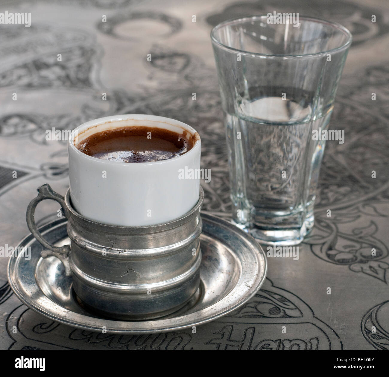 A Cup Of Traditional Turkish Coffee And Accompanying Glass Water A Cup Of Traditional Turkish Coffee And Accompanying Glass Water
