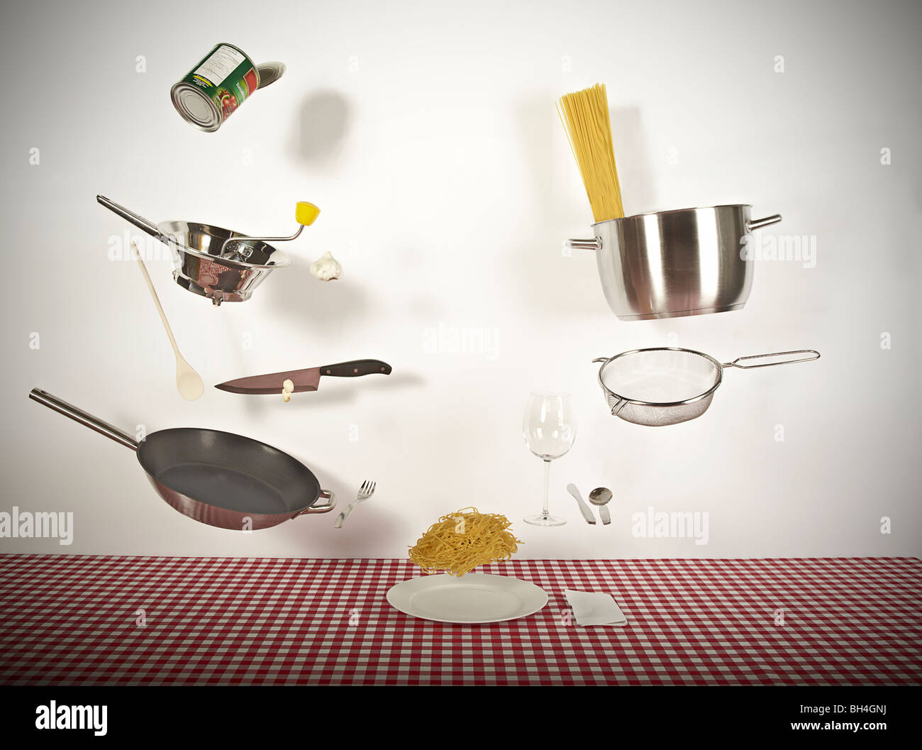 Ingredients and utensils used to make spaghetti and tomato sauce