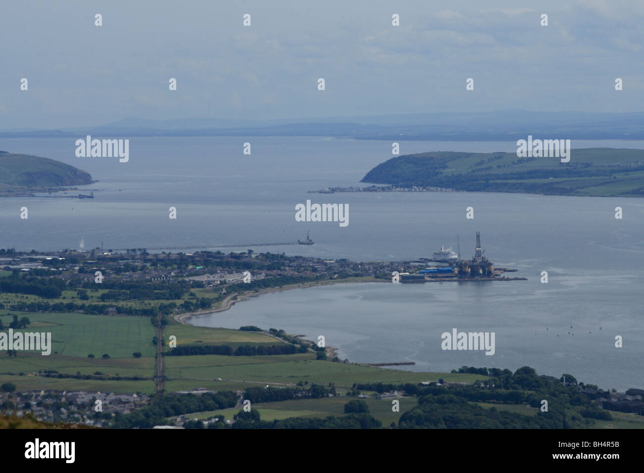 View of Cromarty Firth looking out to the North Sea with Alness, Cromarty, a cruise liner and oil rig construction works. Stock Photo