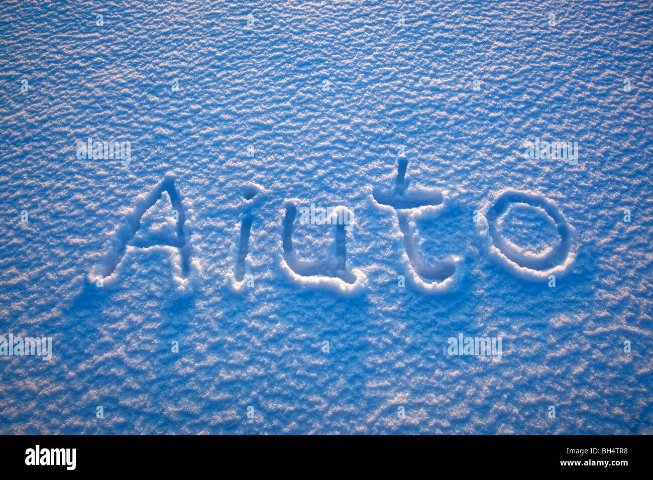 The Italian Word For Help Aiuto Spelled Out In The Snow Stock Photo 