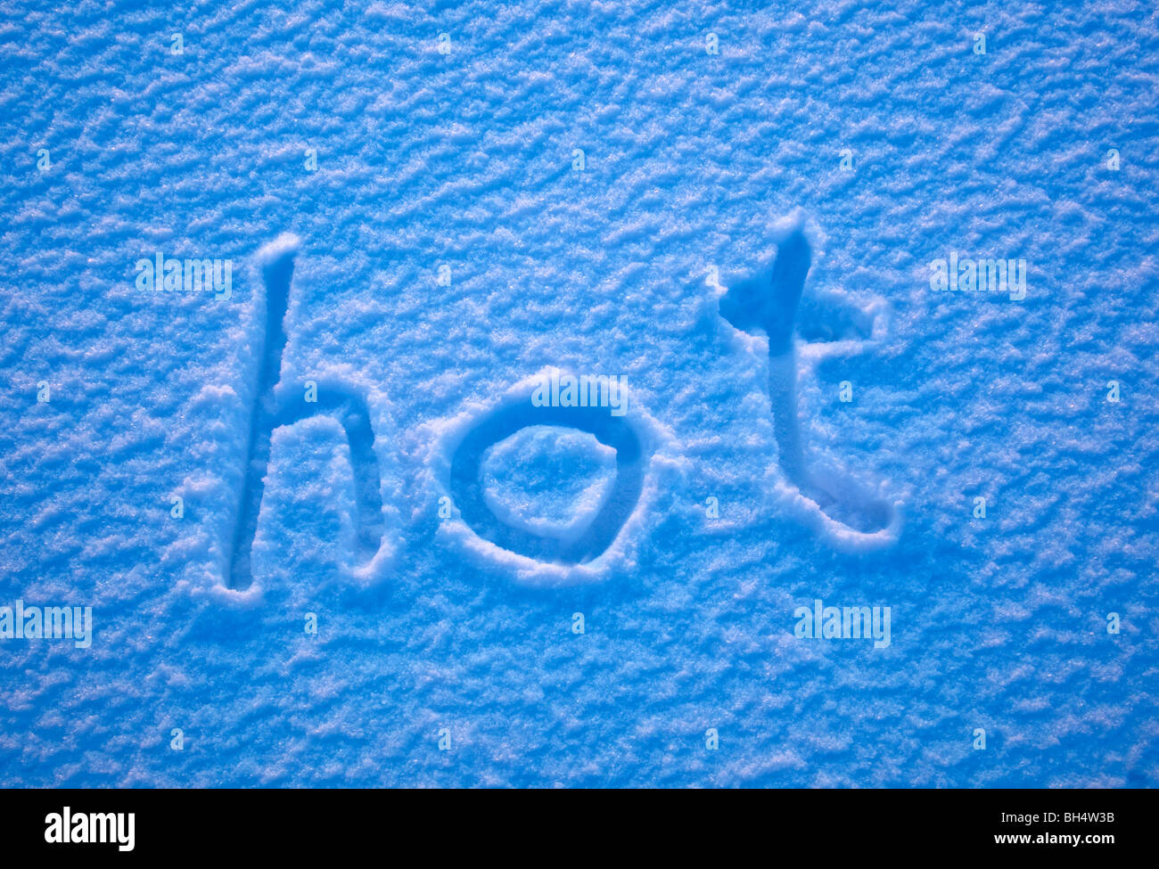 The word 'hot' written in the snow. Stock Photo