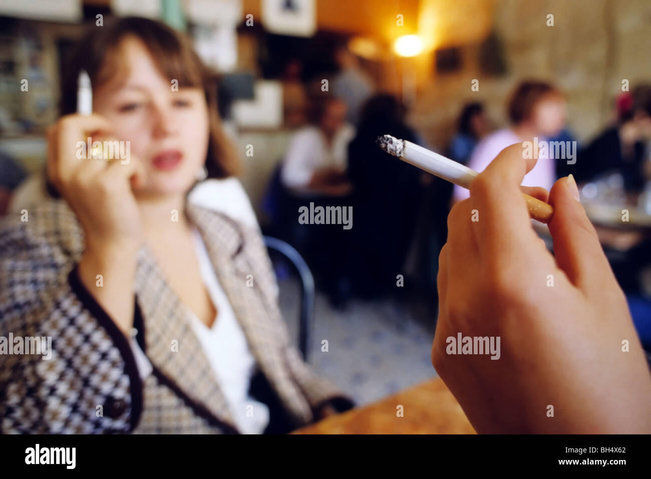 cigarette place TWO CIGARETTE SMOKERS IN A PARISIAN CAF? (PUBLIC PLACE), PARIS (75), FRANCE  Stock Photo