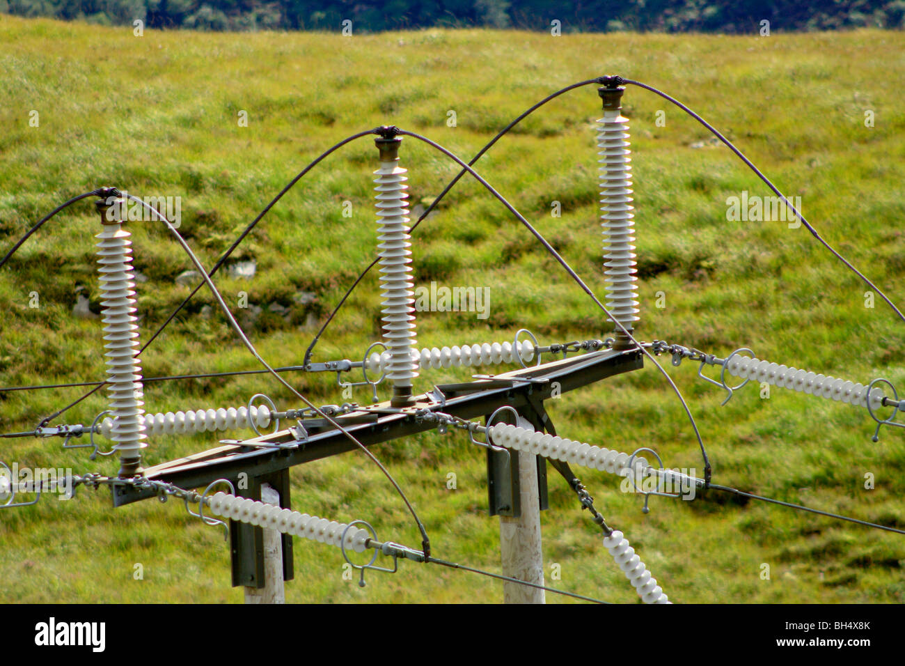 Closeup of high voltage power cables and insulators on a pylon Stock