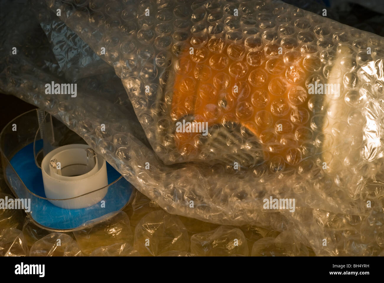 Pottery is wrapped in bubble wrap prior to being shipped Stock Photo Alamy
