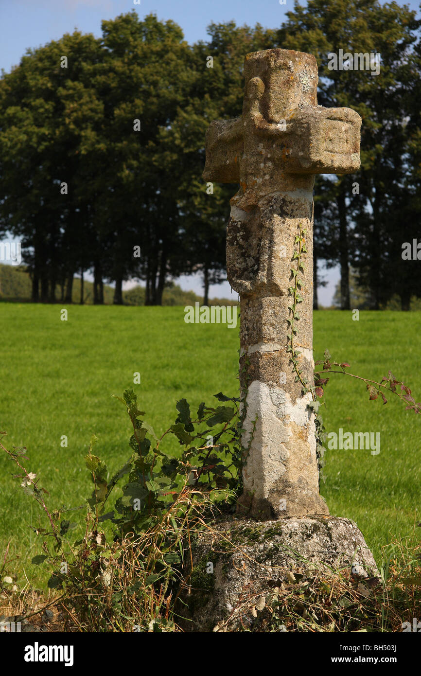 A stone cross beside a road near Champnetery in the Limousin region of France. Stock Photo