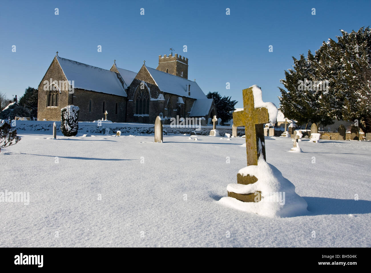 Ducklington Village church in snow Stock Photo
