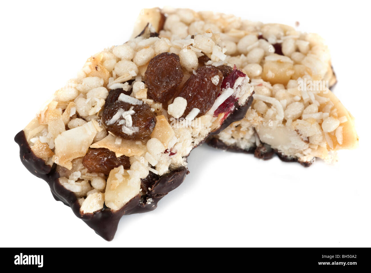 Close up of a broken halved Fruit, nut and chocolate healthy eating bar Stock Photo