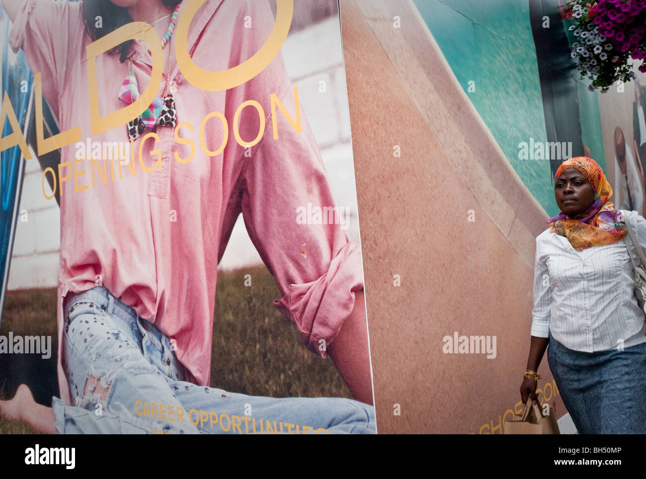 African Muslim woman walking past an advertising hoarding for Aldo Shoes in  Dublin Ireland Stock Photo - Alamy