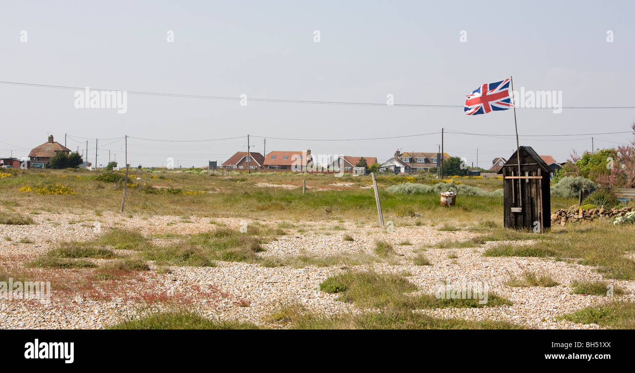 Union jack flying on small outside toilet shed Stock Photo