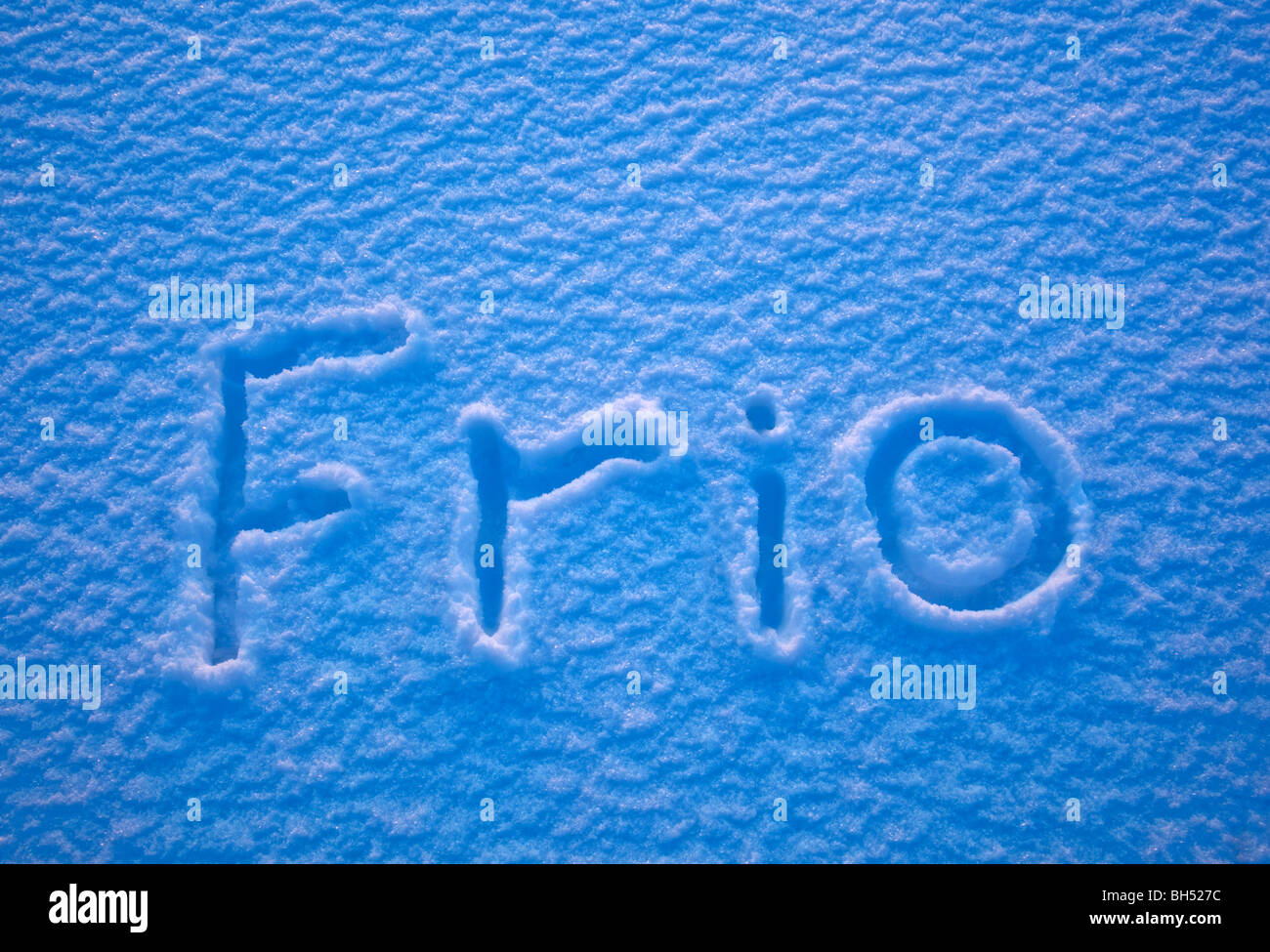 the Spanish word for cold - Frio - spelled out in the snow Stock Photo