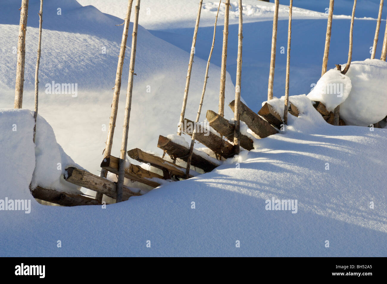 Traditional Norwegian skigard fence in deep snow. Stock Photo