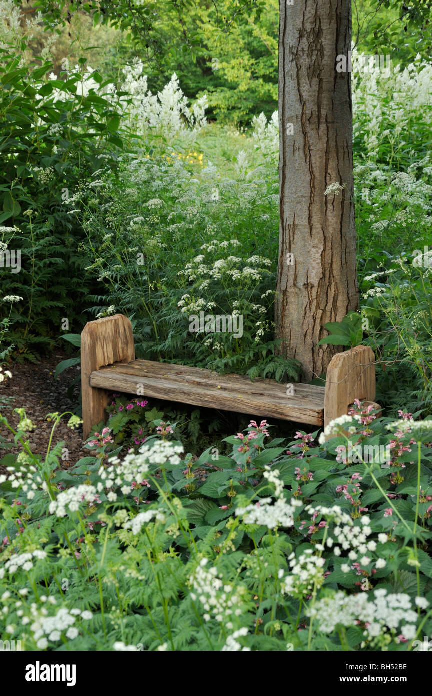 Basic bench in a perennial garden Stock Photo