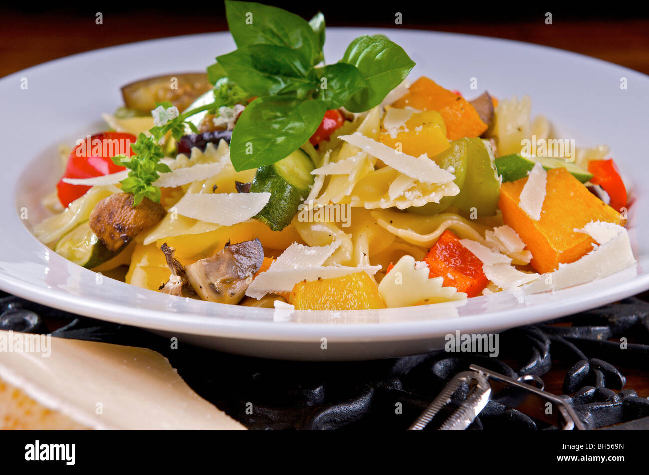 Pasta and roasted vegetable dish plated on white plate Stock Photo