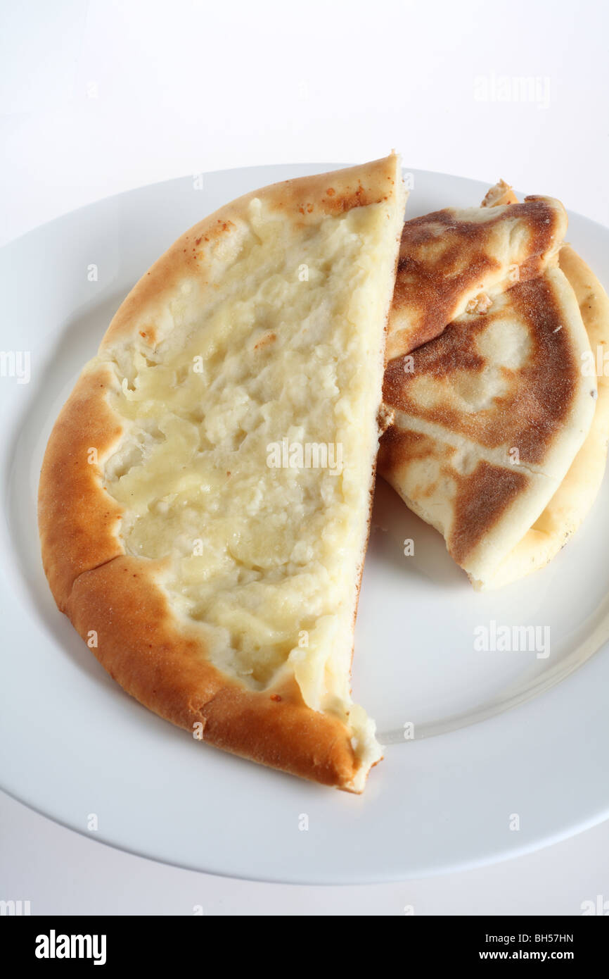 A fataya bread with halloumi cheese topping - Arabia's answer to the pizza - on a white plate. Stock Photo