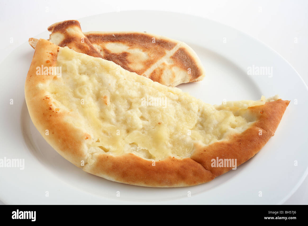 A fataya bread with halloumi cheese topping - Arabia's answer to the pizze - on a white plate. Stock Photo