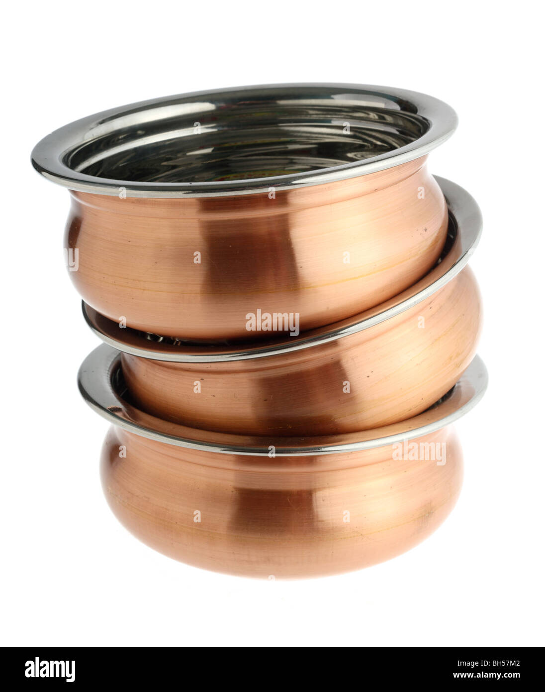 A pile of copper-coated Indian restaurant-style serving bowls isolated over  a white background, no shadow Stock Photo - Alamy