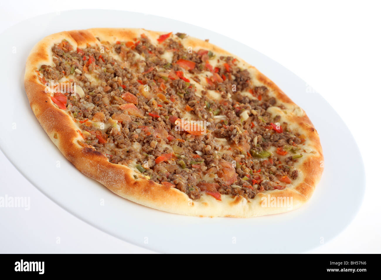 A fataya Arab bread, which is dough topped with meat and pickled vegetable sauce before baking. Stock Photo