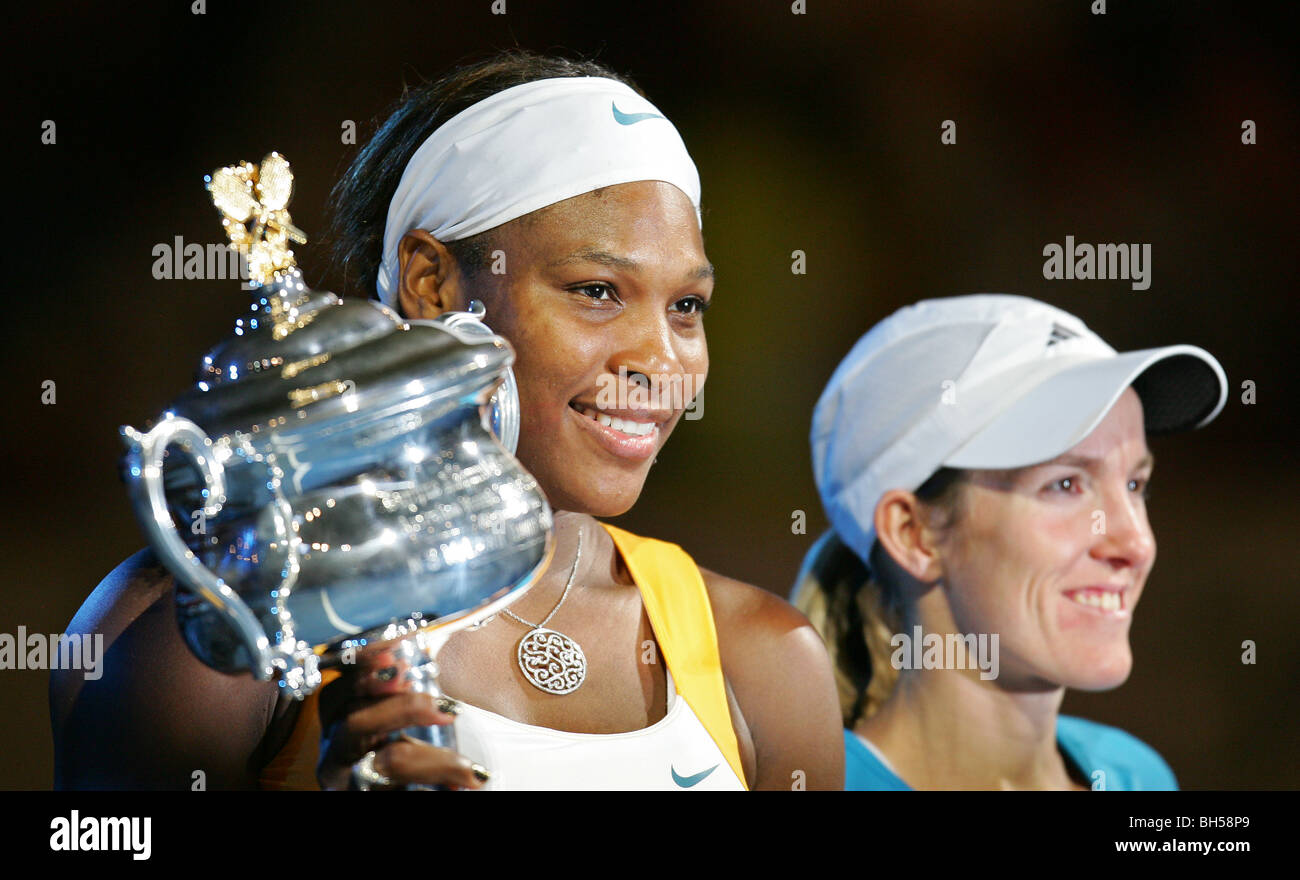 Serena Williams (L) poses with the trophy after winning her women's final match against Justine Henin. 2010 Australian Open Stock Photo