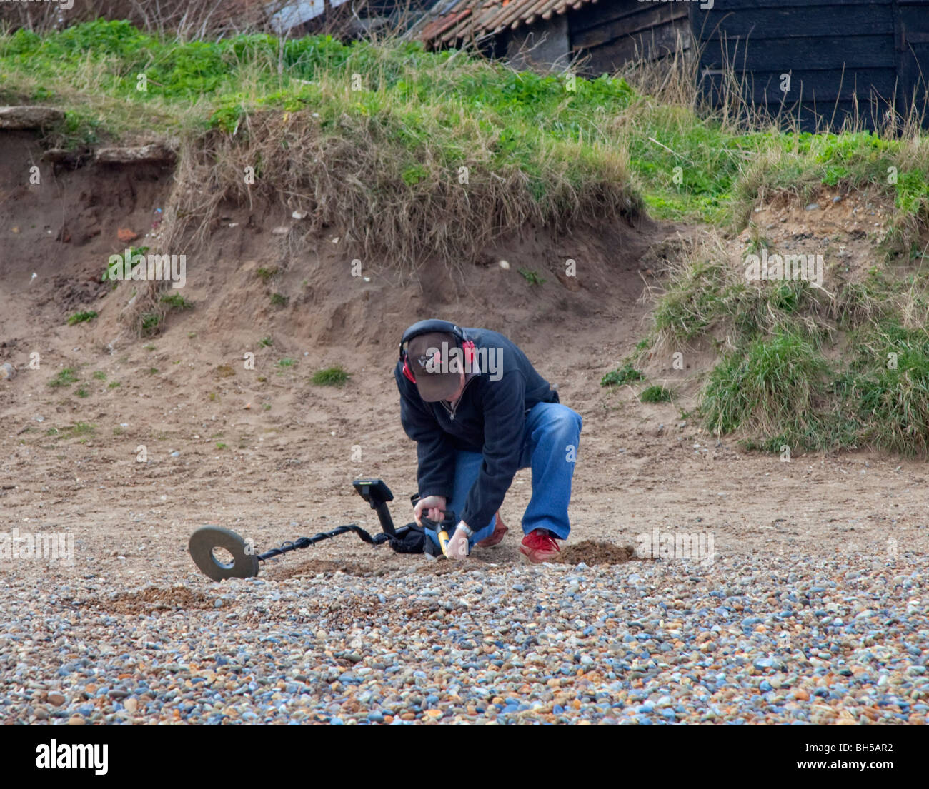 with Metal Detector on beach in Suffolk, England Stock