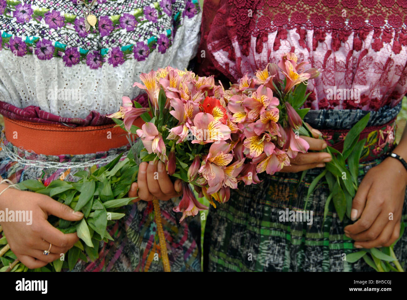 GUATEMALA Native Quiche girls and women picking flowers and vegetables