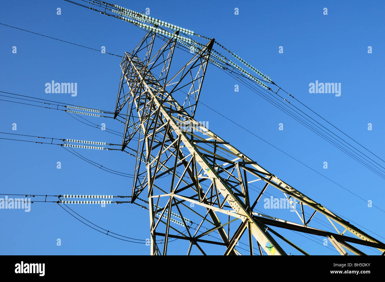 UK National Grid Electricity pylon and blue sky viewed upwards Stock Photo