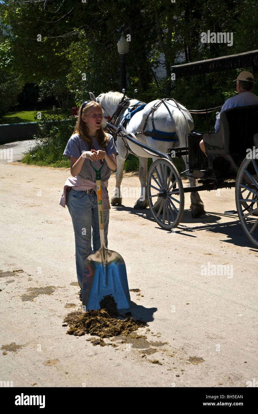 girl-shovelling-horse-manure-clearing-th