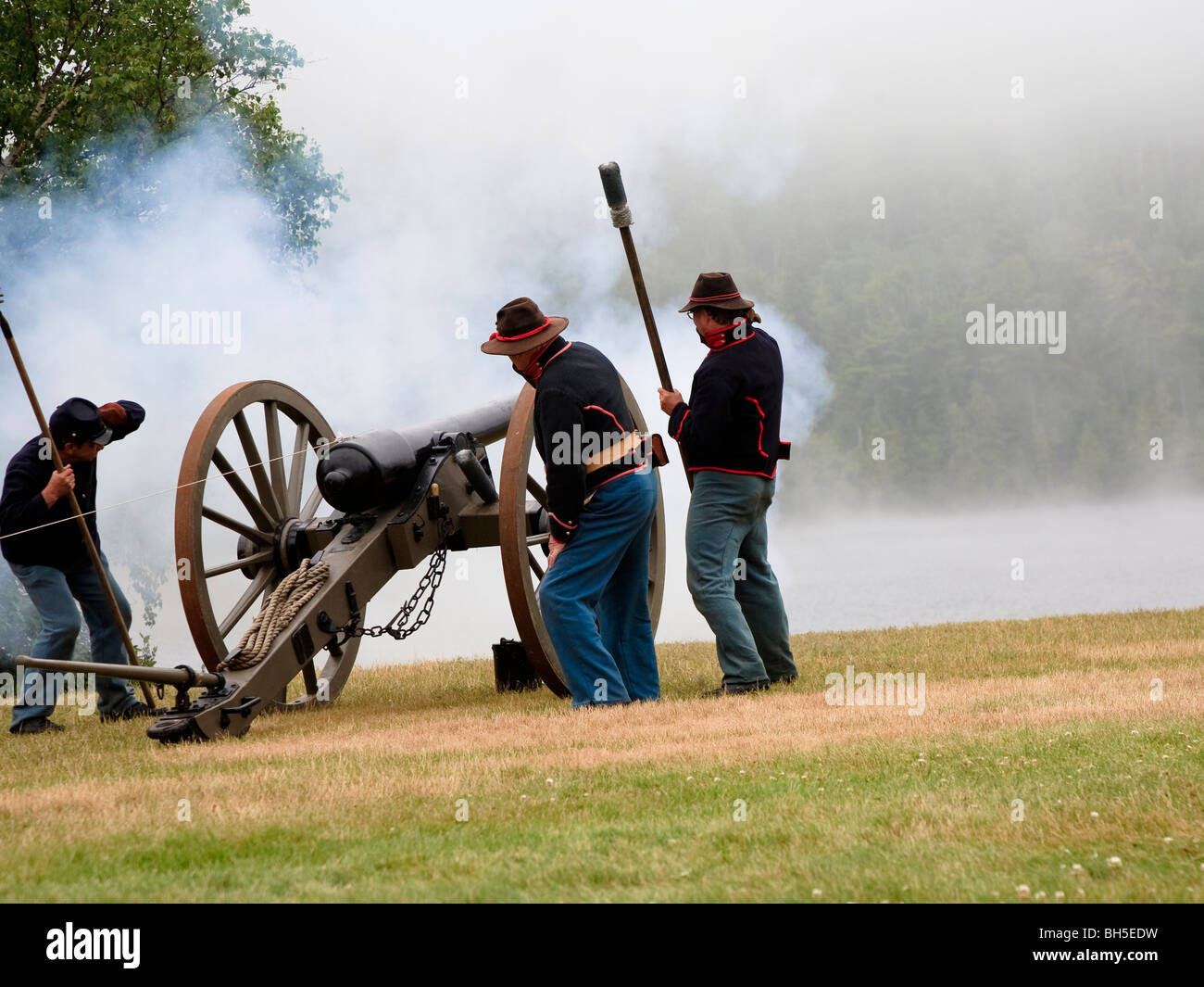 Battery D, 1st Michigan Light Artillery, a Civil War-era living-history group, fire their cannon during a reenactment weekend. Stock Photo
